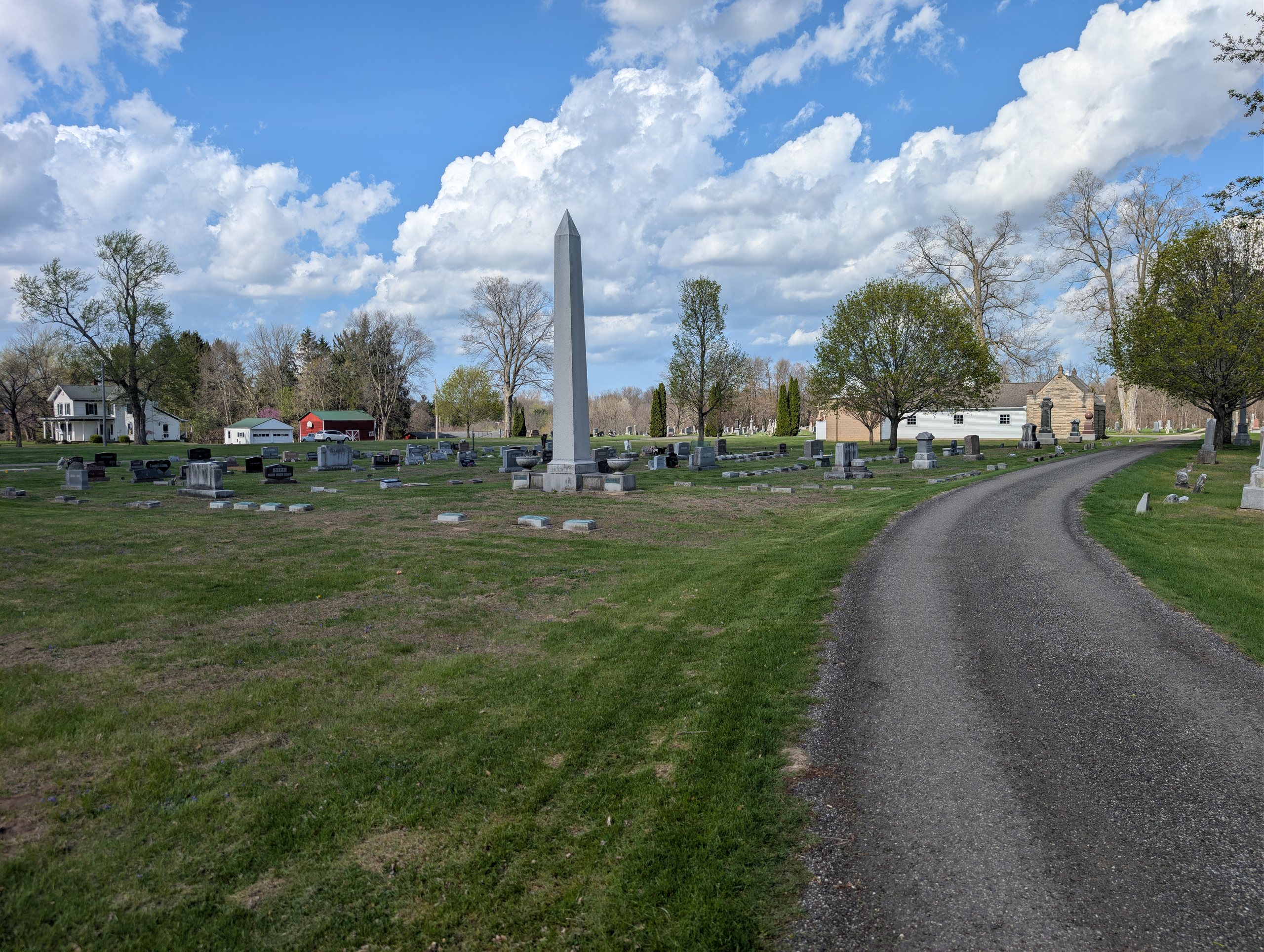Milan Cemetery landscape with trees, lawn, and grave markers